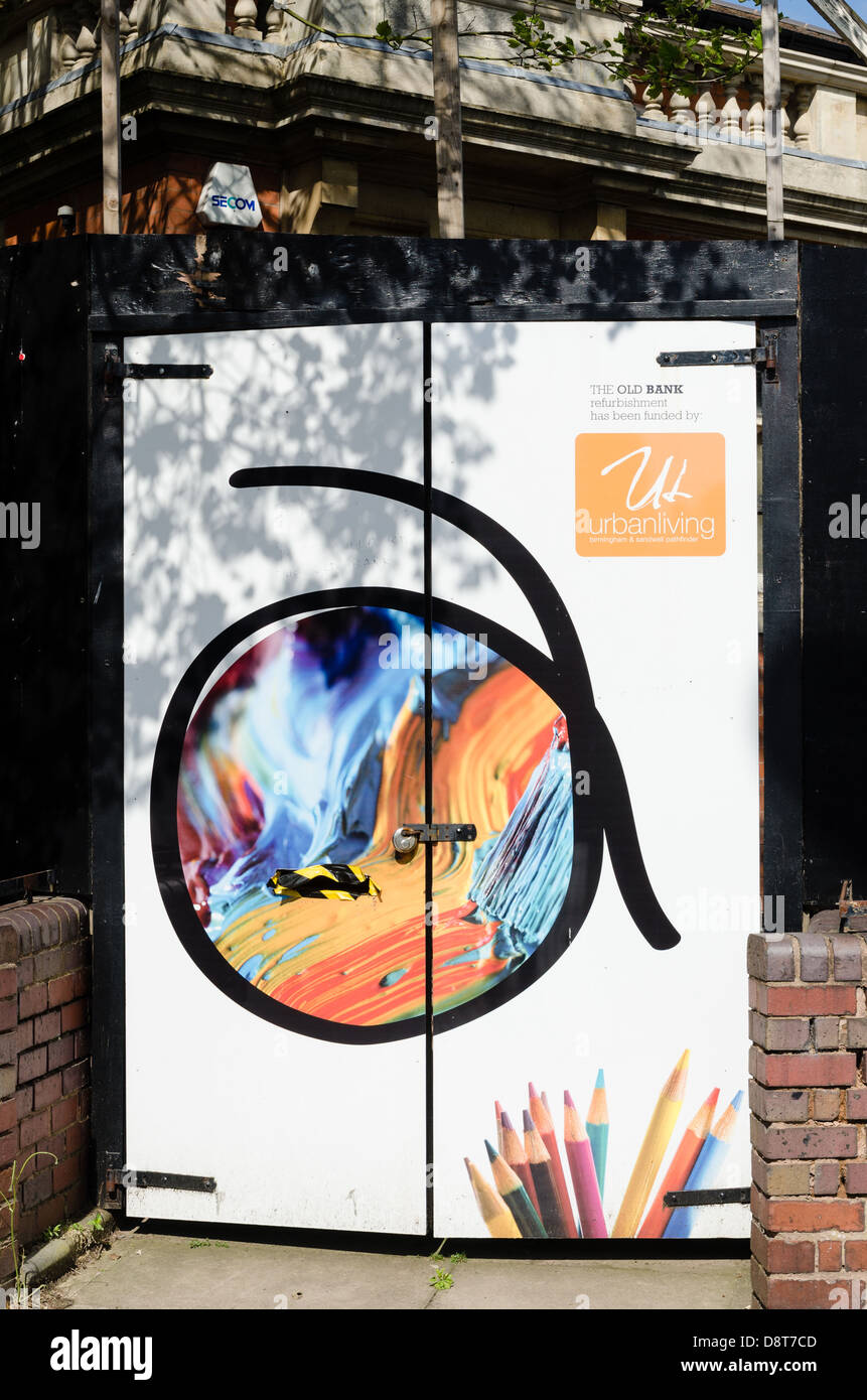 Decorative painted doors at entrance to a building refurbishment in Handsworth, Birmingham Stock Photo