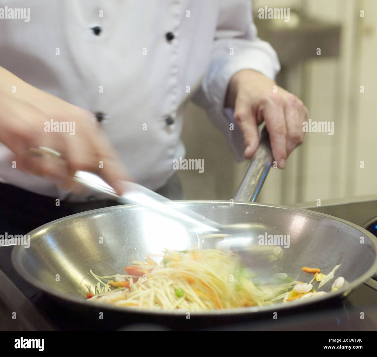 Chef cooking stir fry and noodles Stock Photo - Alamy