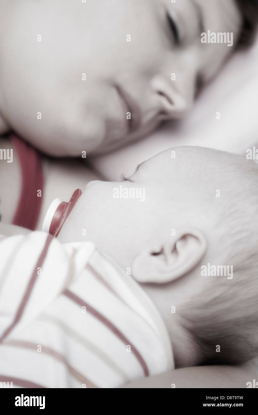 Sleeping baby in the arm of his mother Stock Photo Alamy