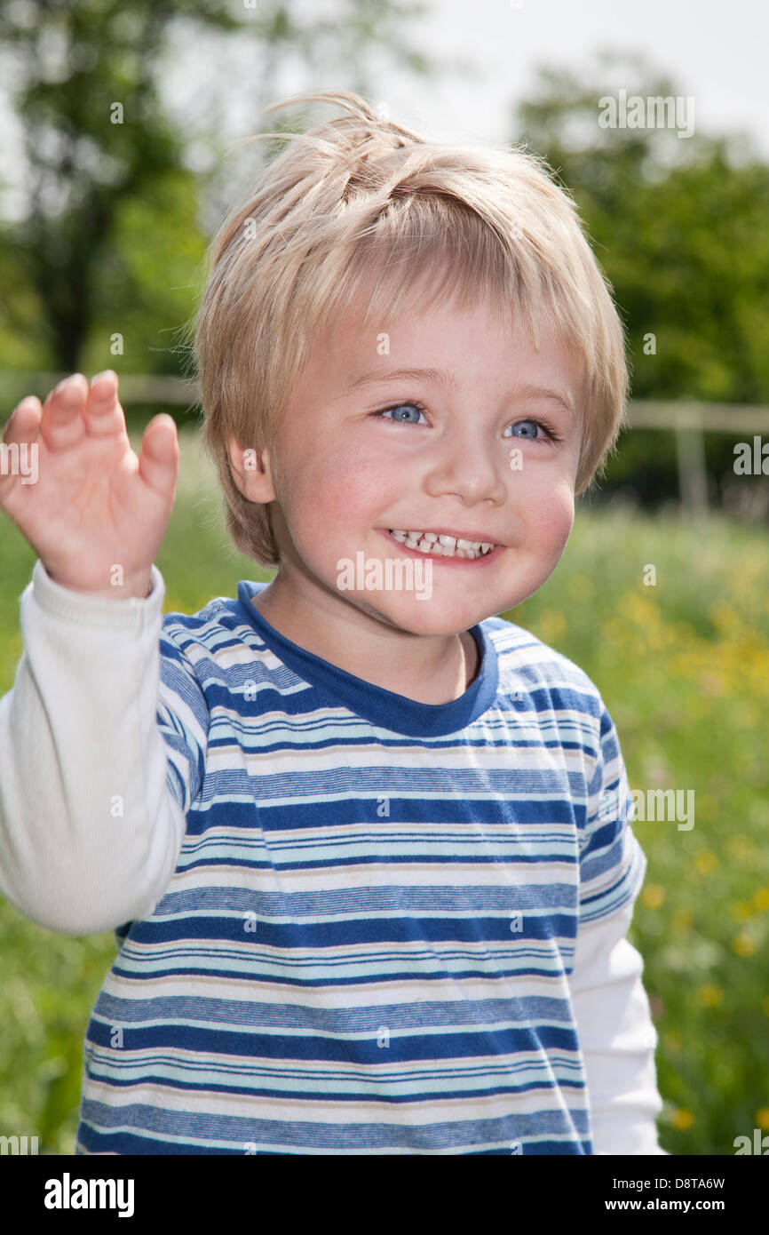 Three year-old boy waving his hand Stock Photo