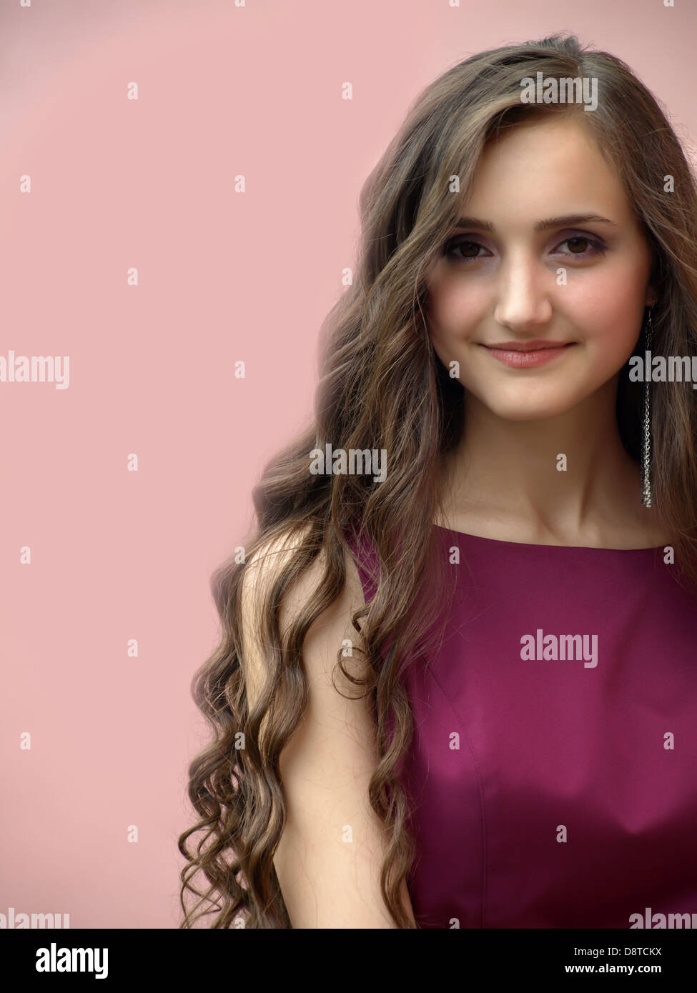 Beautiful girl smiling on background of the pink wall Stock Photo - Alamy