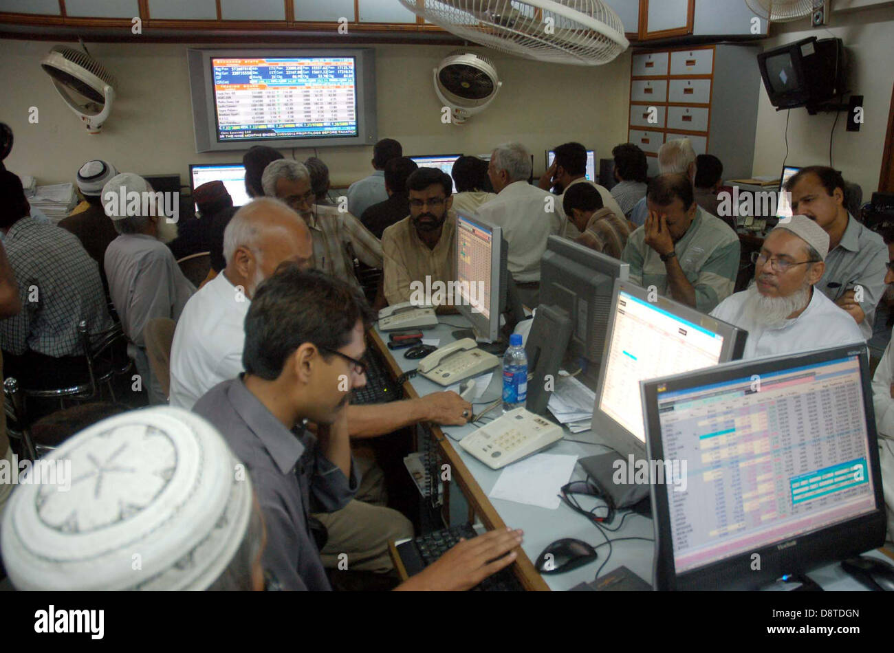 Pakistani stockbroker busy in trading during a trading session at the
