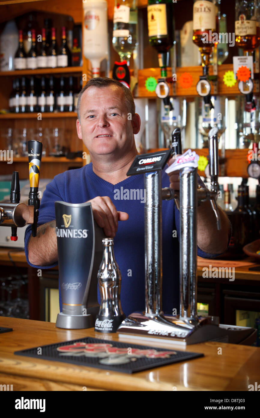 Pub landlord, nigel jones, in his pub in South Wales, UK Stock Photo