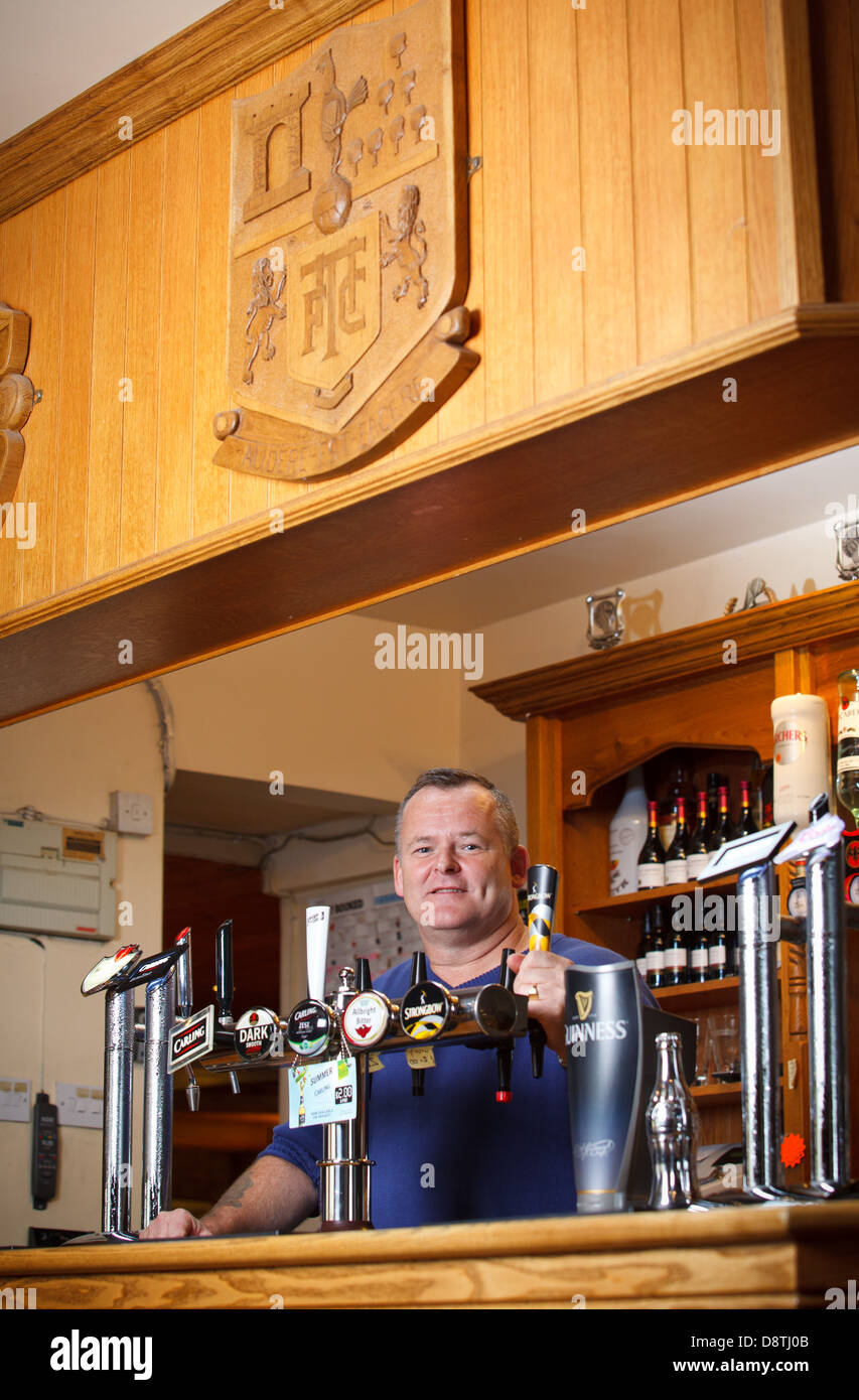 Pub landlord, nigel jones, in his pub in South Wales, UK Stock Photo