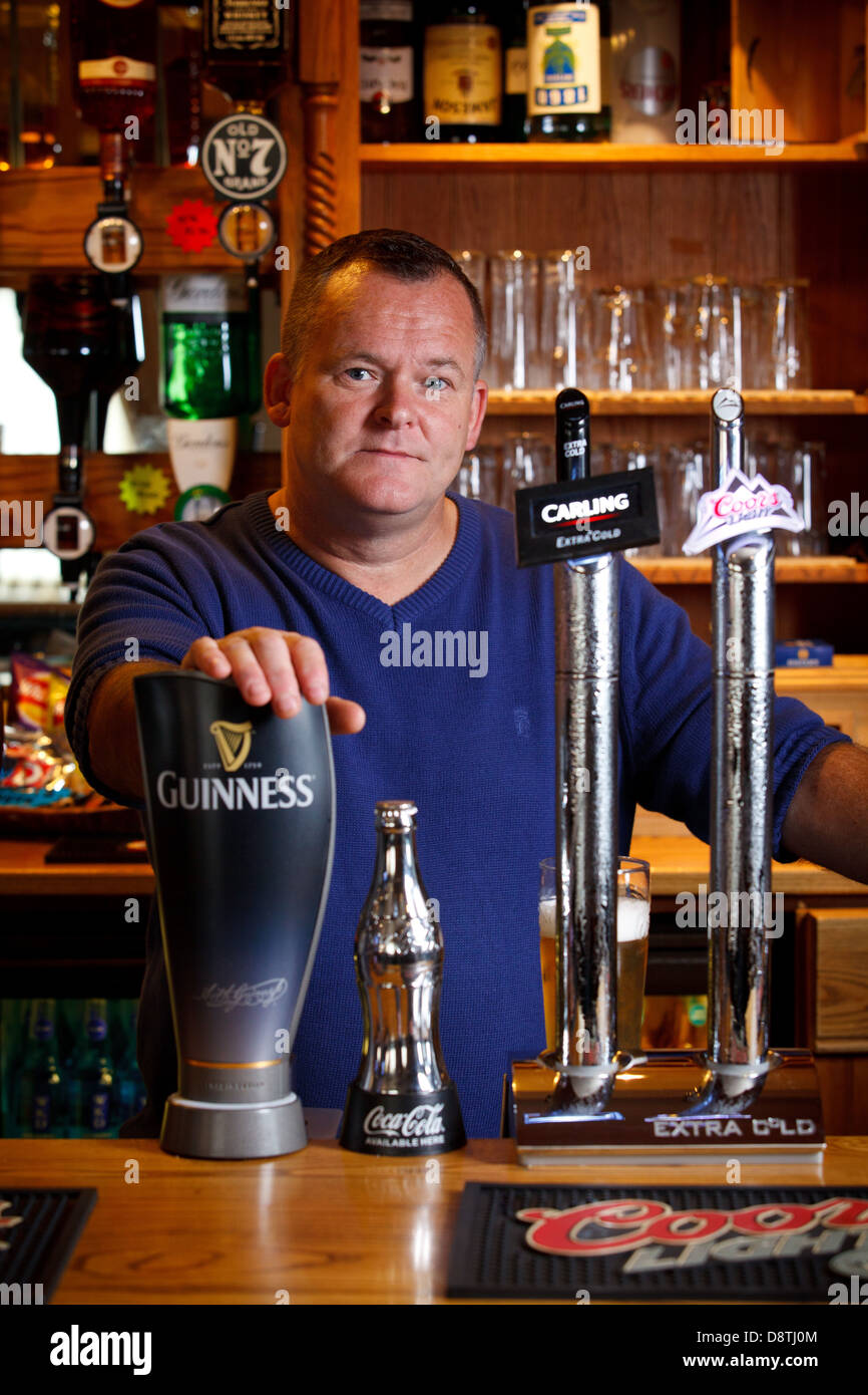 Pub landlord, nigel jones, in his pub in South Wales, UK Stock Photo