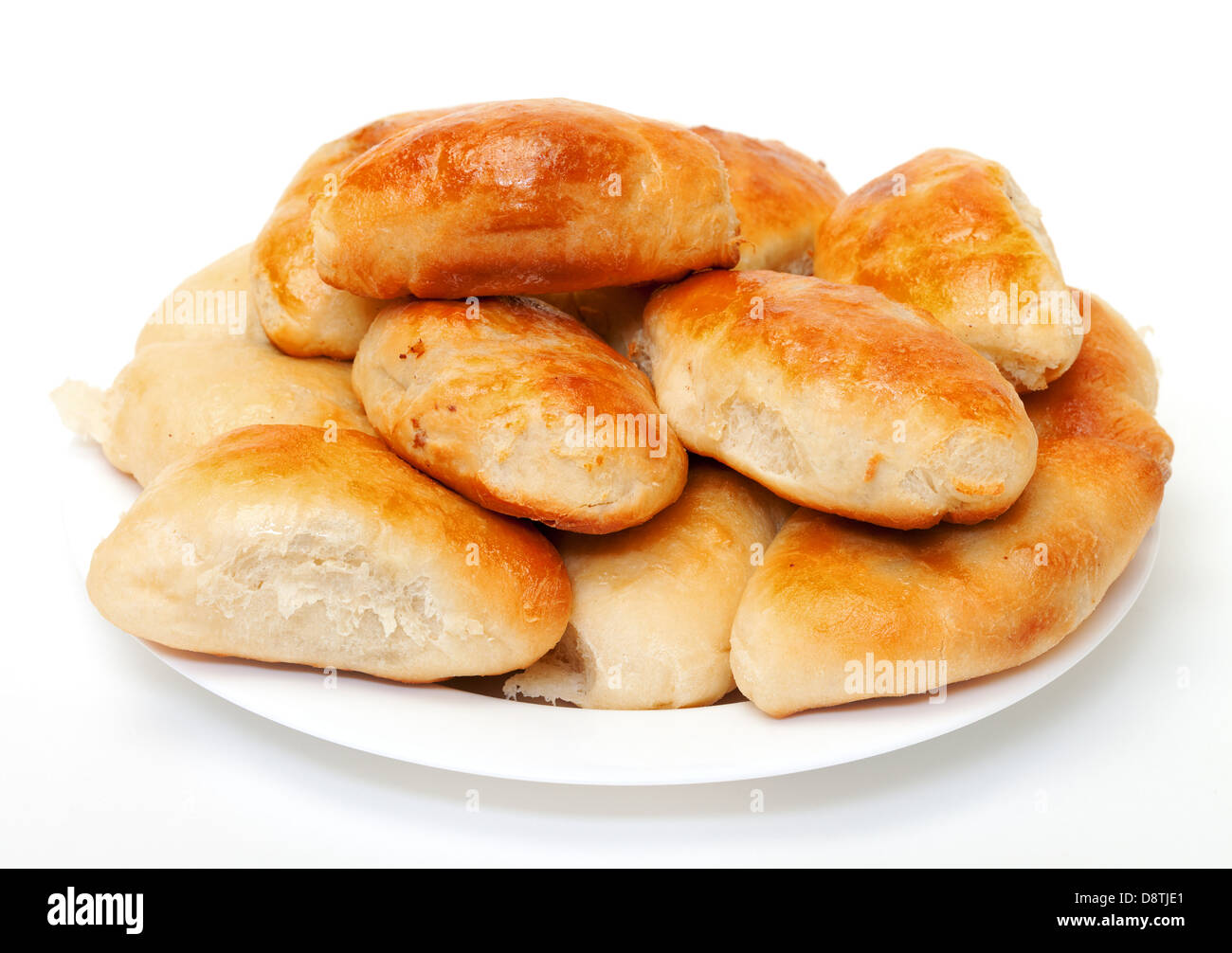 Heap baked patties on plate, white background Stock Photo