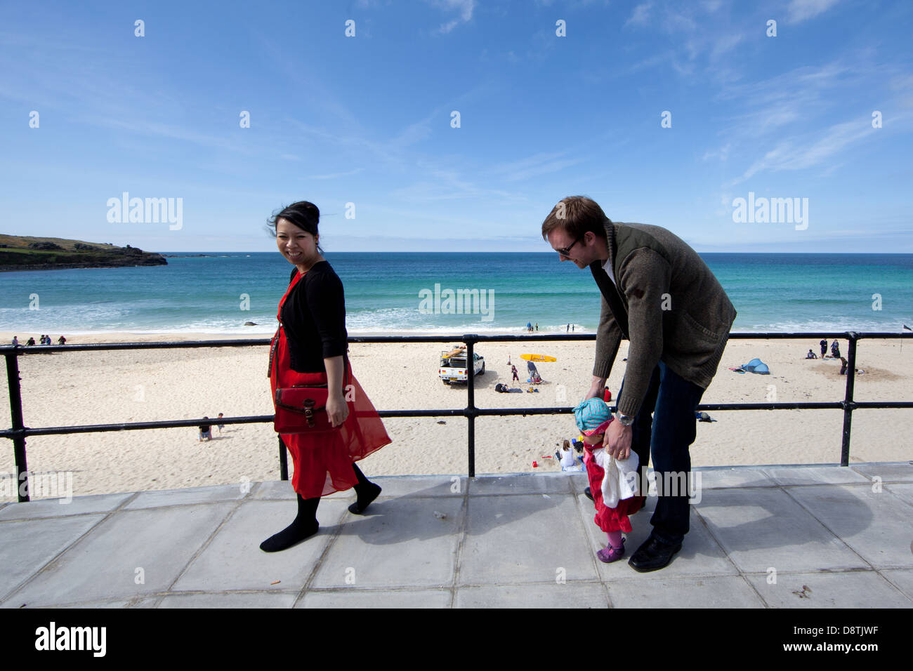 Family takes a stroll on the beach hires stock photography and images