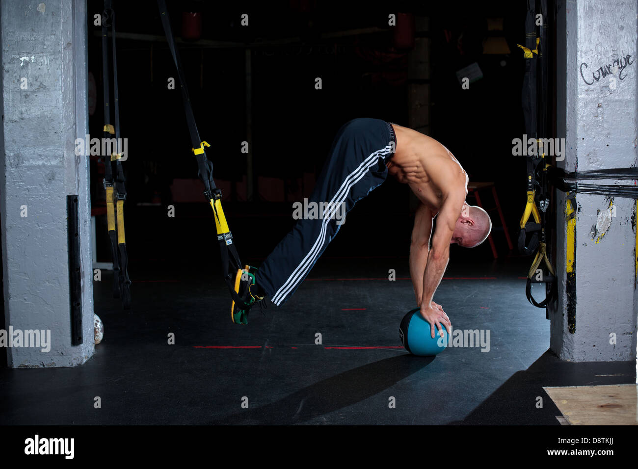 Personal Trainer Rhys John, working out with series of body weight exercises in a gym. Stock Photo