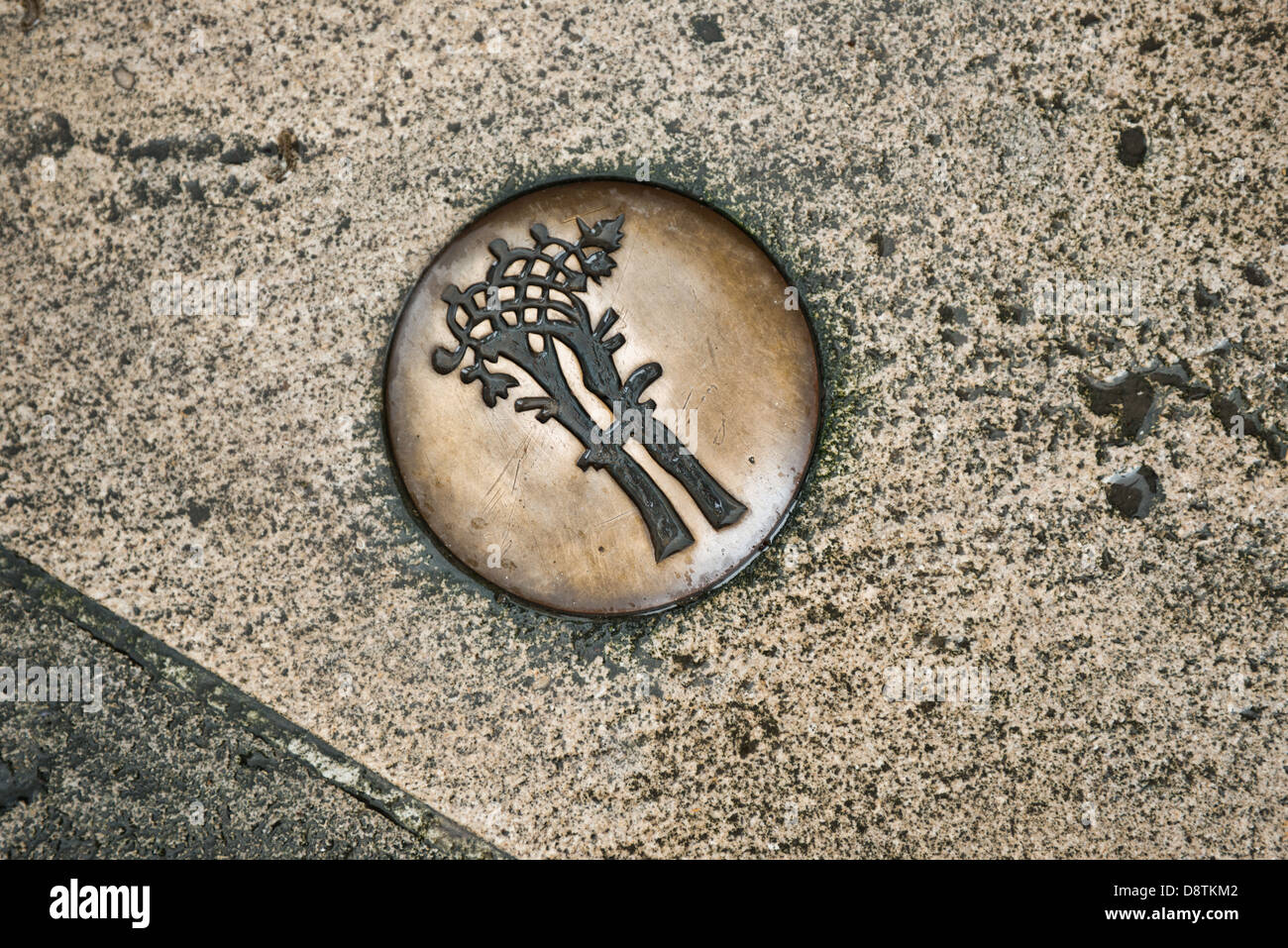 A brass plaque embedded in the pavement in Bayeux, Normandy as a guide to places of interest Stock Photo