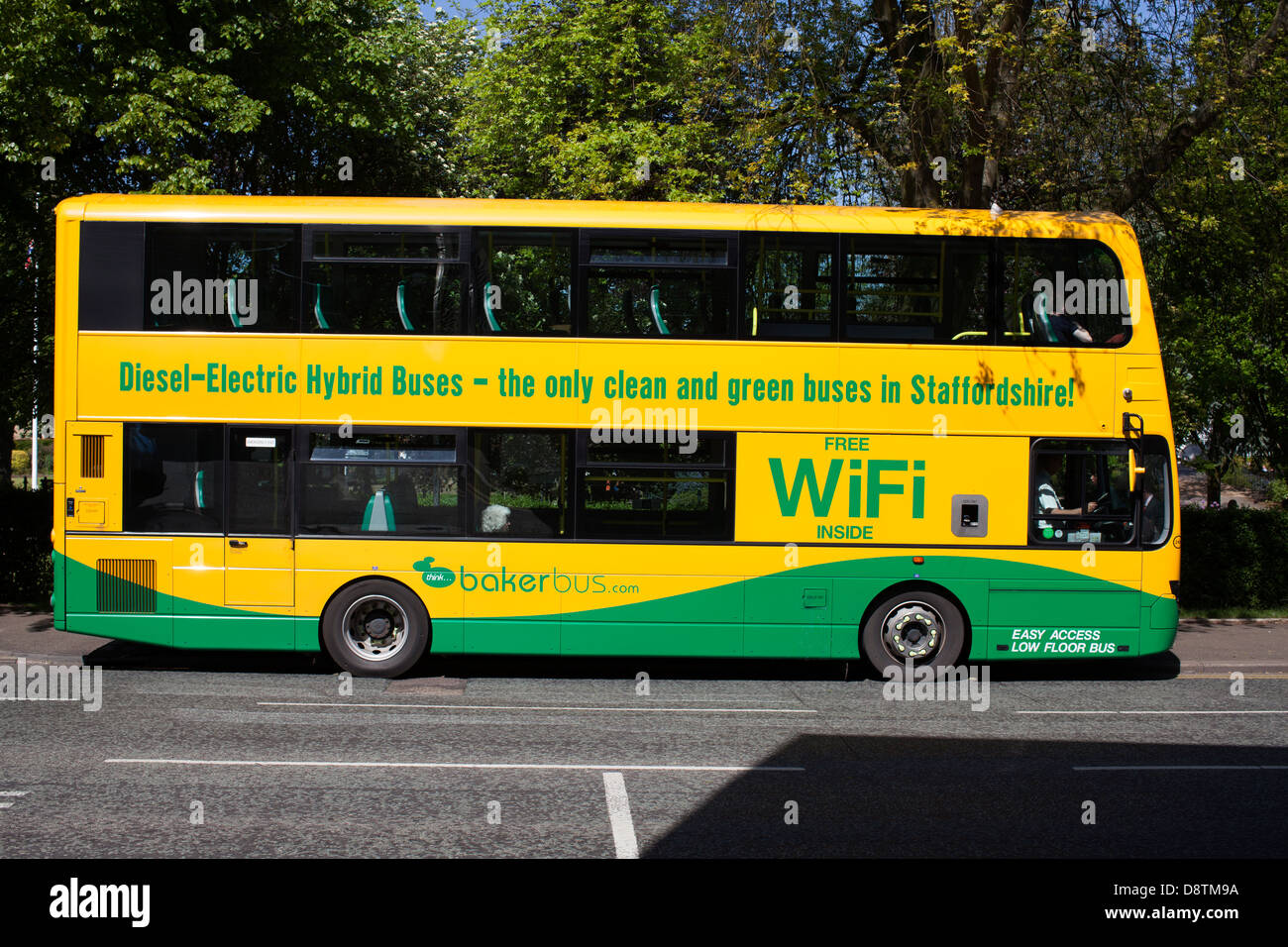A diesel electric hybrid double decker bus painted green and yellow with wifi advertisement on a Baker bus in the UK Stock Photo