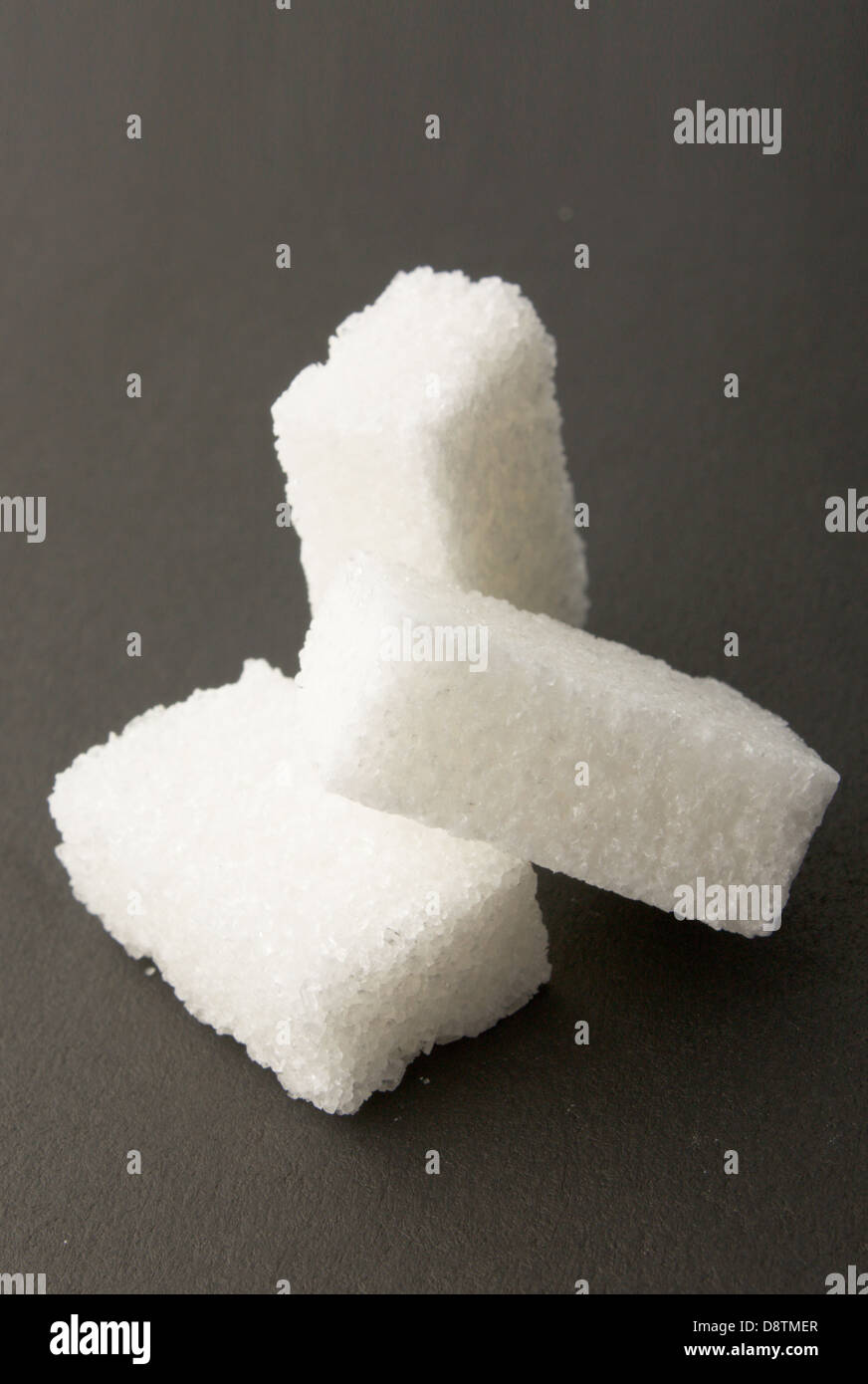 lump of sugar on the black background Stock Photo - Alamy