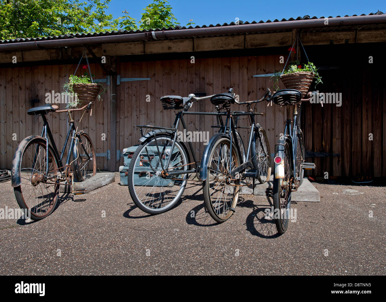 Vintage push bicycles on old fashioned concrete bike stands Stock Photo