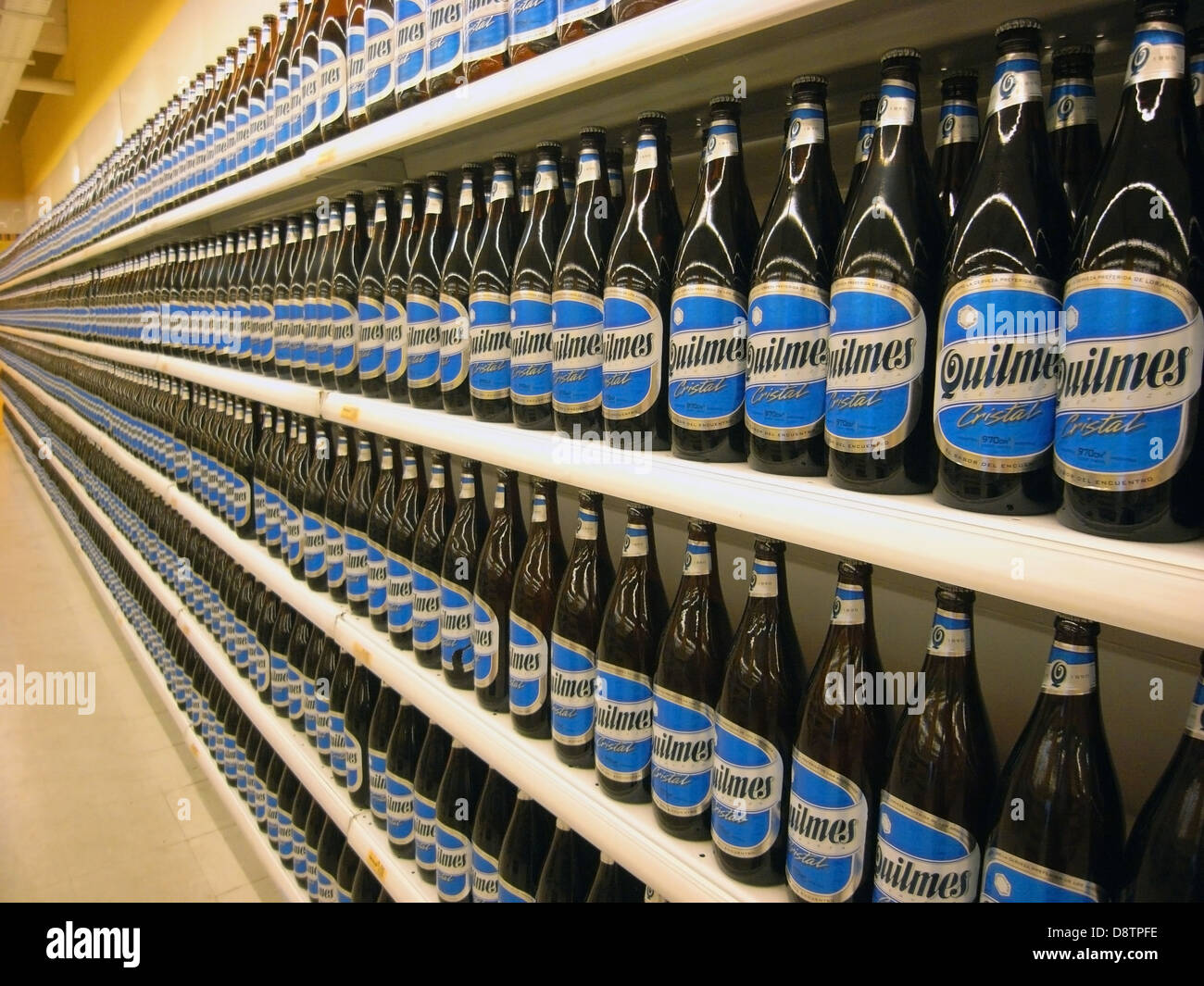 Supermarket shelves overstocked with Quilmes beer bottles, Buenos Aires, Argentina. No PR Stock Photo