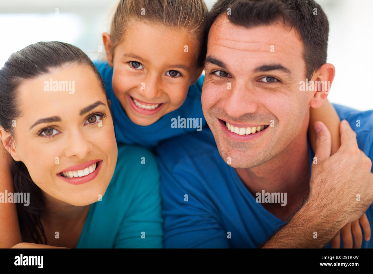 cute family of three face closeup portrait at home Stock Photo Alamy