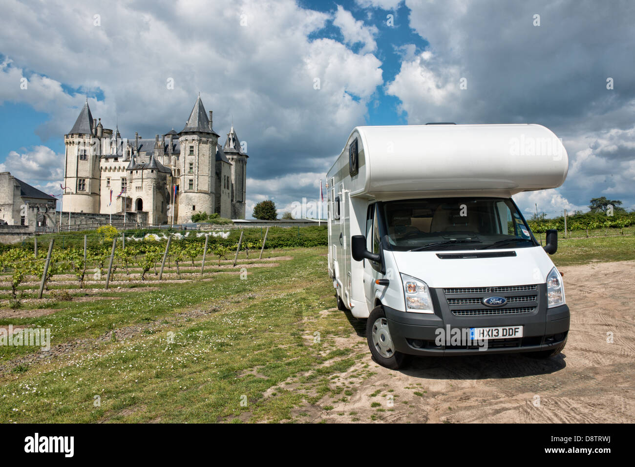 A Ford  Transit motorhome parked by the vinevards in front of the historic Château de Saumur in the Loire valley, France. Stock Photo