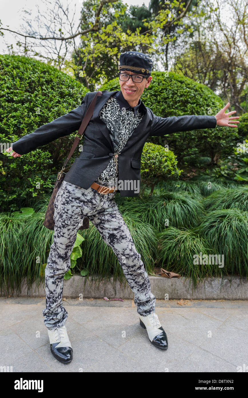 one stylish fashionable chinese man posing smiling at the city of Shanghai in China Stock Photo