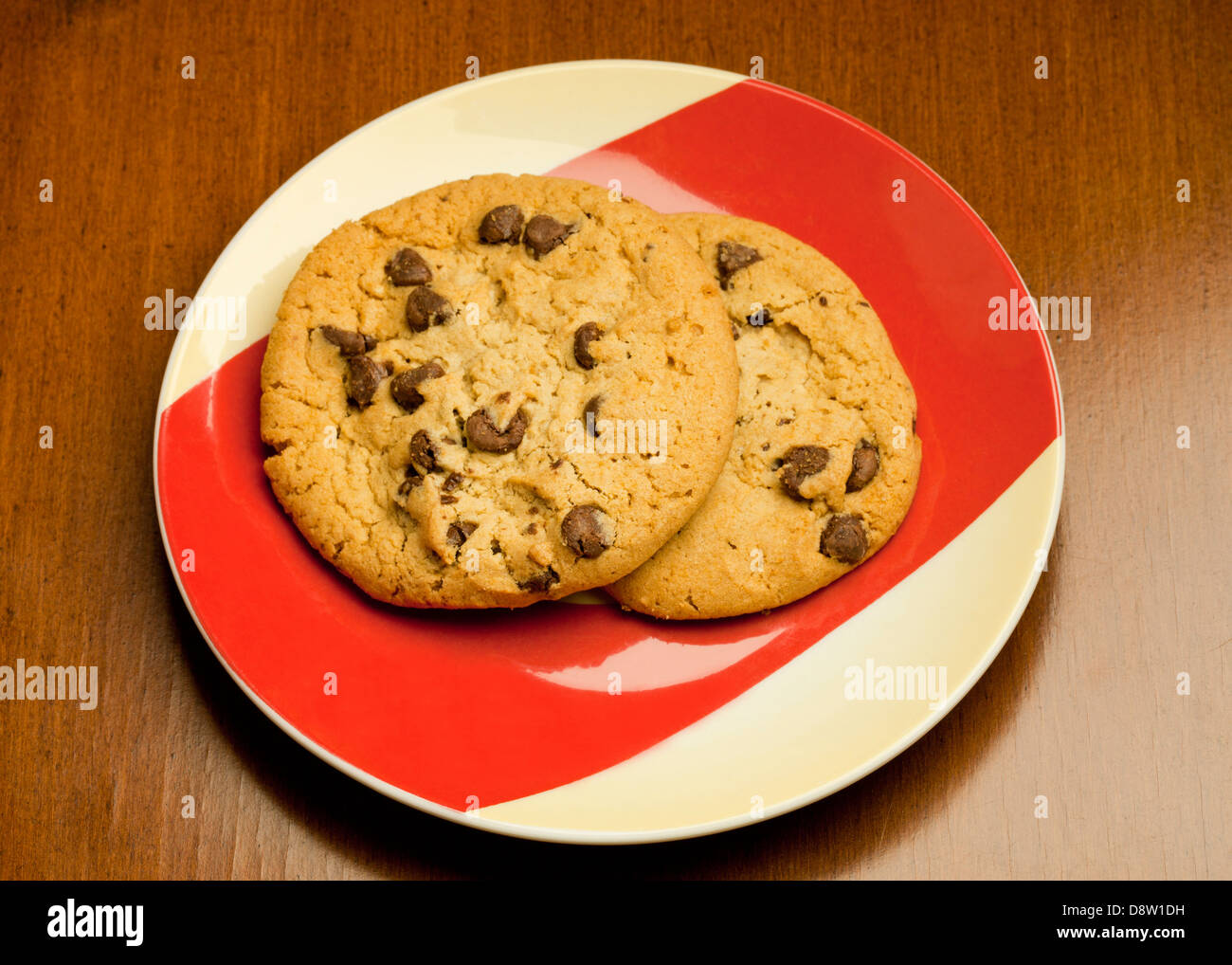 Two chocolate chip cookies on plate Stock Photo
