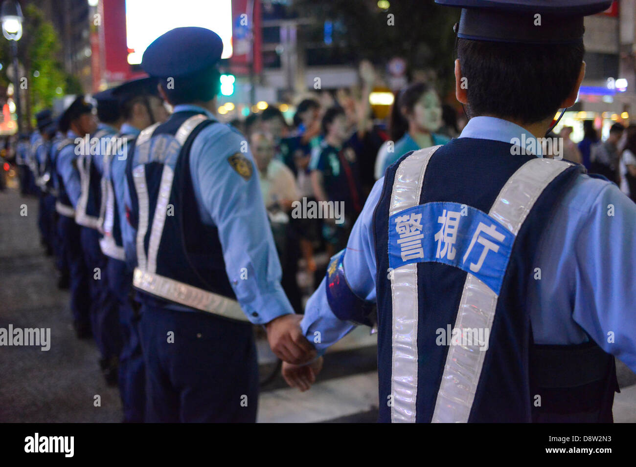 Saitama, Japan. 4th June 2013. June 4th, 2013 : Tokyo, Japan - Police Officers restricted pedestrians and celebrating fans of the Japan National Soccer team, which had a game of the final Asian qualifiers for the 2014 World Cup against Australia and cleared it, in front of Shibuya Station, Shibuya, Tokyo Japan on June 4, 2013.  (Photo by Koichiro Suzuki/AFLO/Alamy Live News) Stock Photo