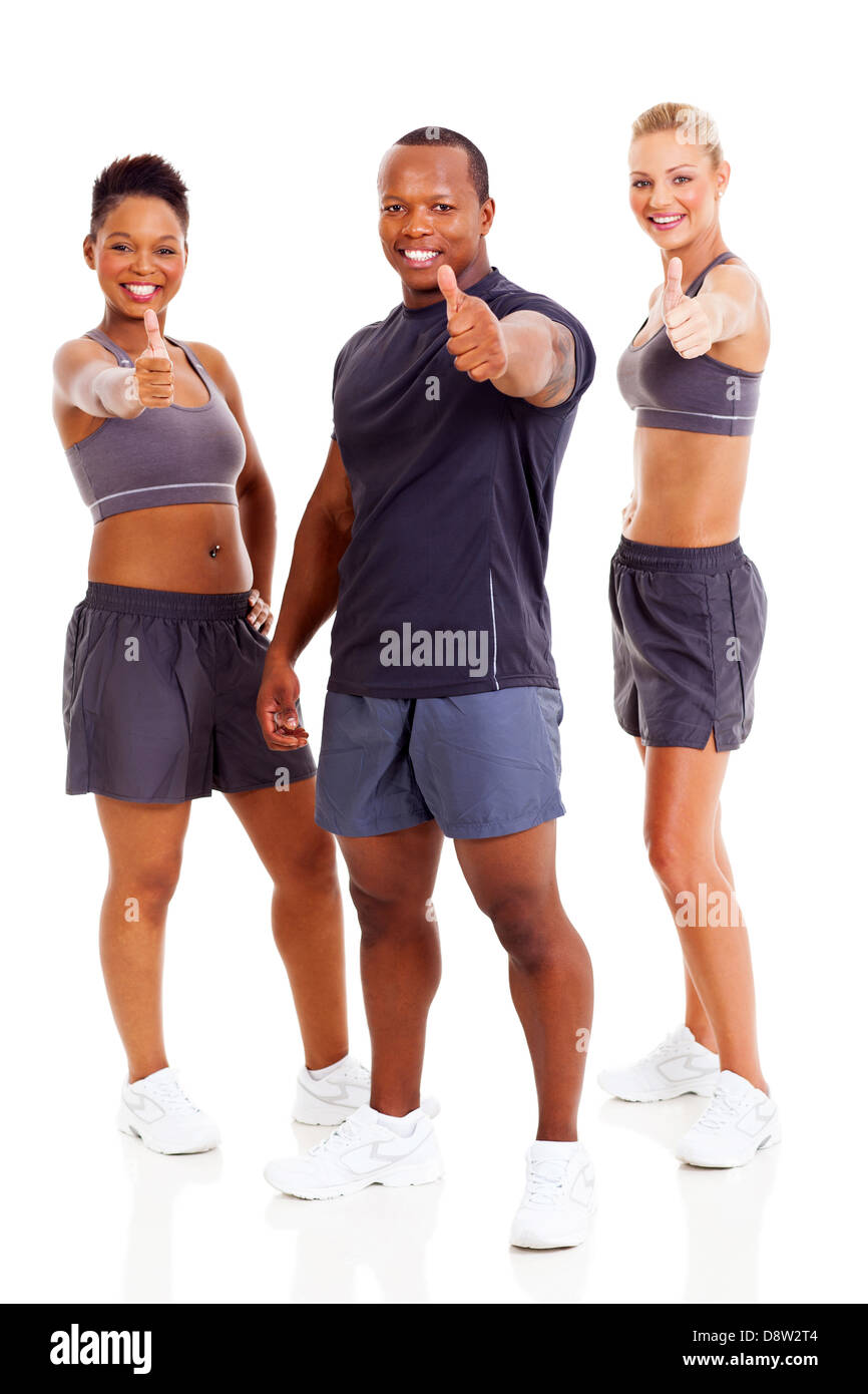 group of happy gym instructors giving thumbs up, isolated on white Stock Photo