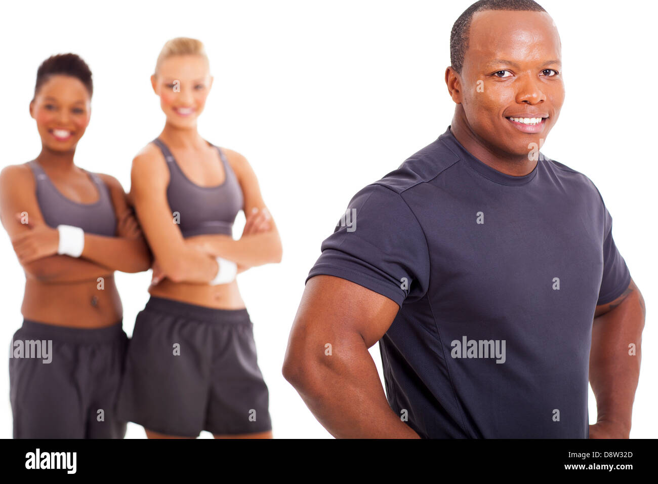 close up portrait of fit african man with two women on background Stock Photo