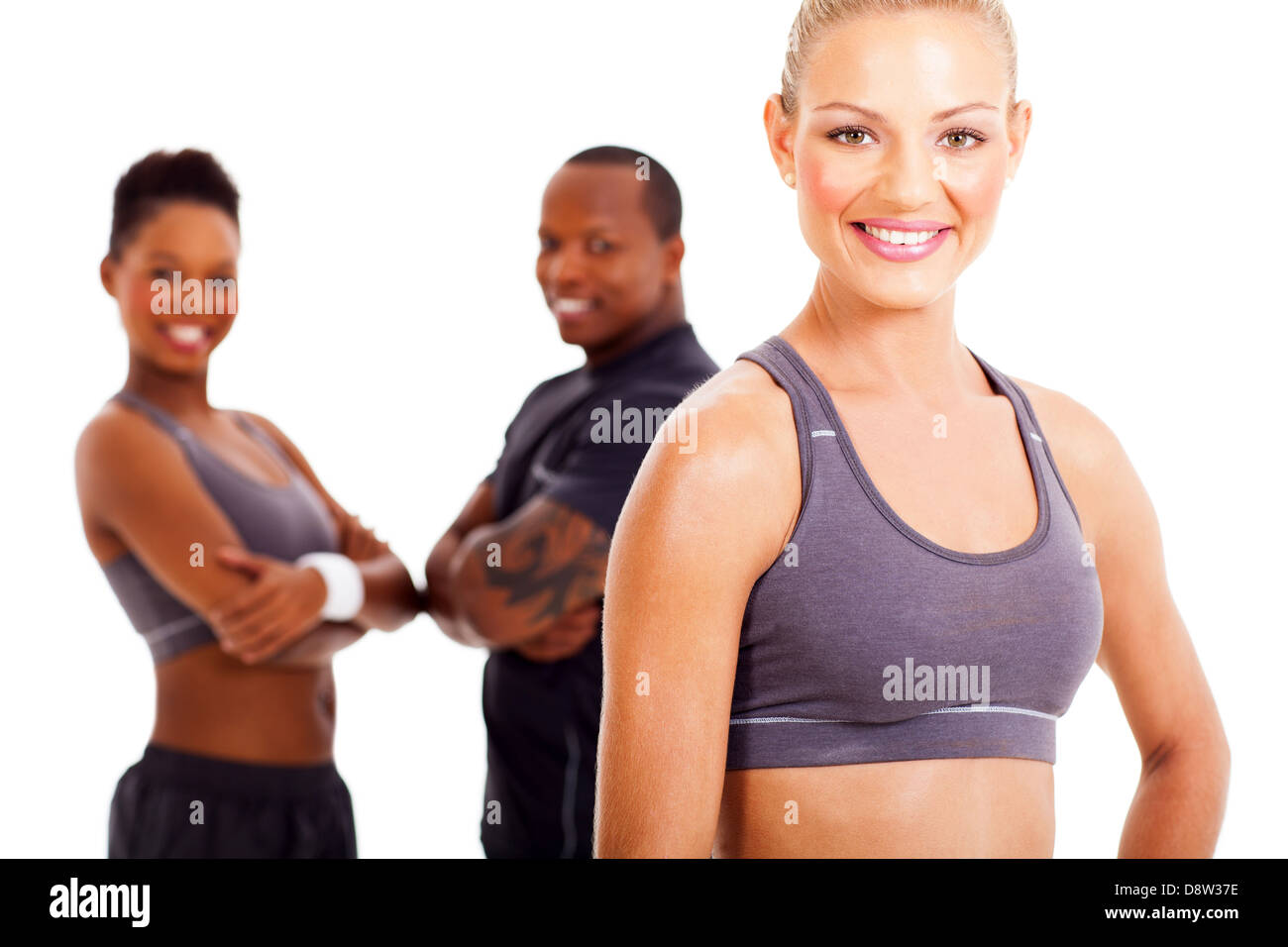 beautiful fit woman and two gym members on background Stock Photo