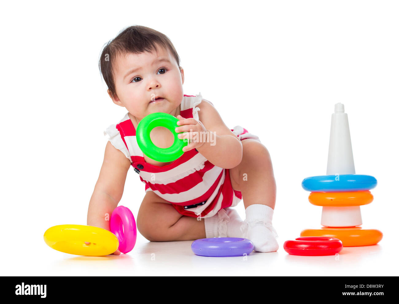 toddler girl playing with pyramid toy Stock Photo
