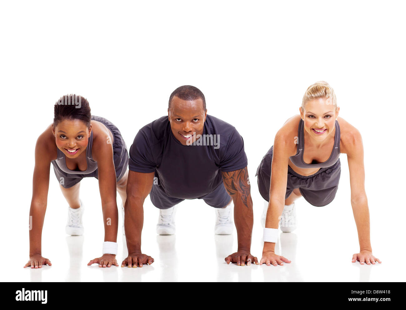group of fit people doing pushups on white background Stock Photo