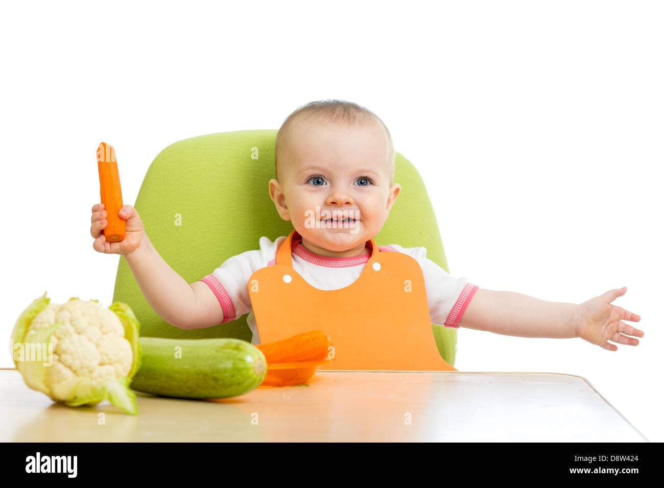 happy baby girl eating vegetables Stock Photo Alamy
