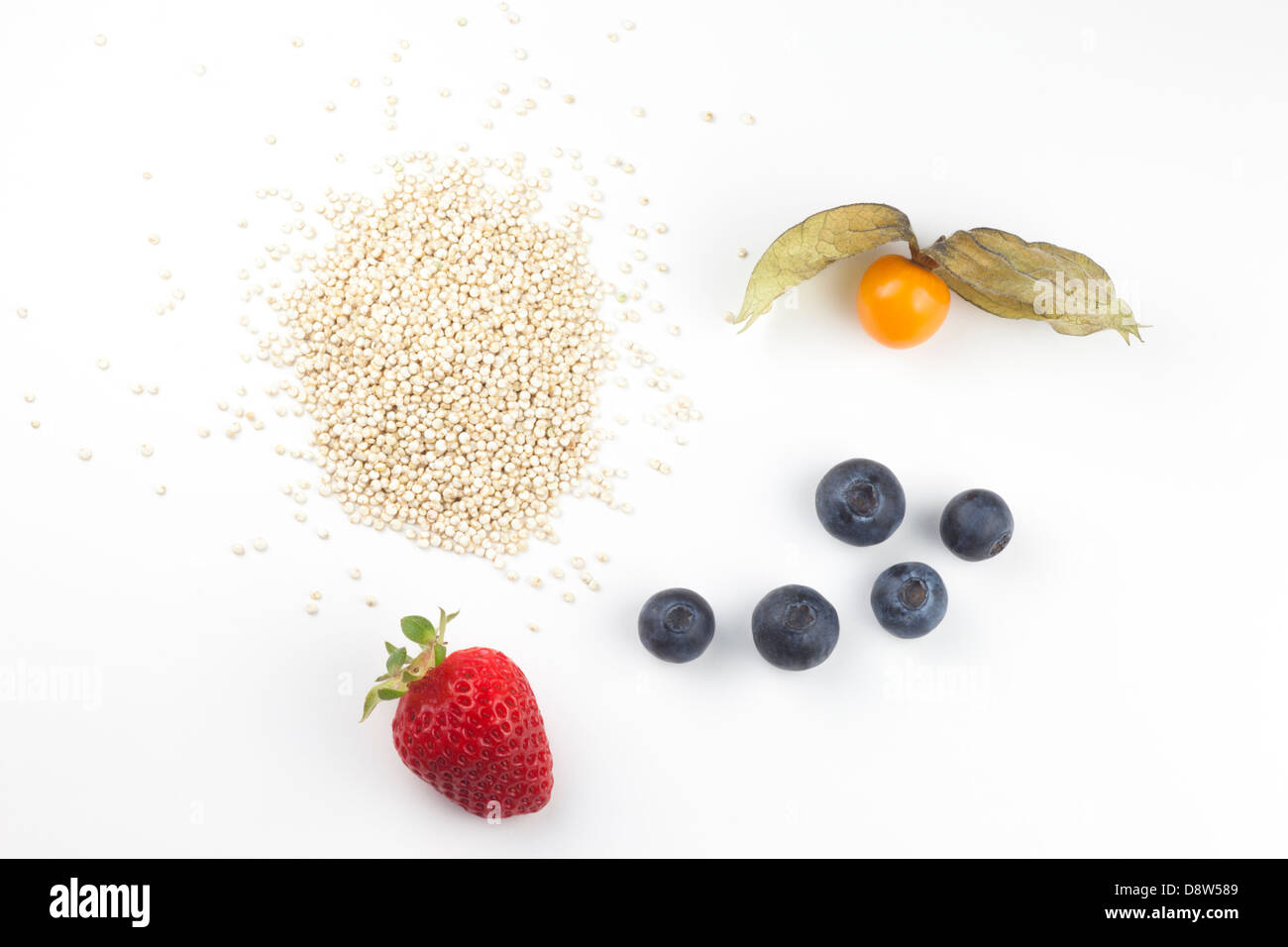 Healthy whole foods: fresh golden berry, strawberry, blueberries and golden quinoa Stock Photo