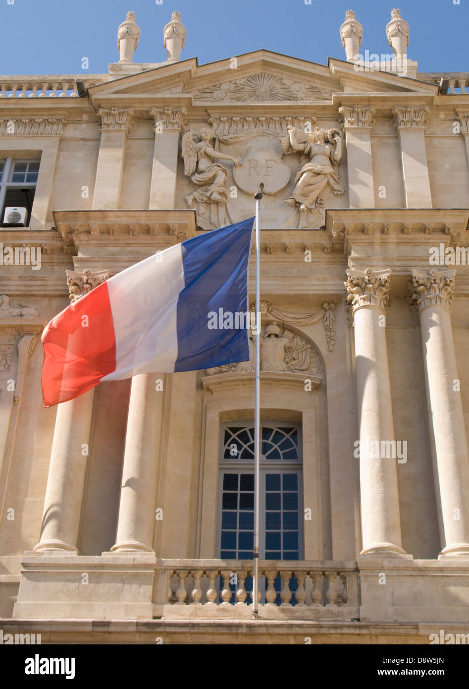 Detail of facade of the Marie (Town Hall) of Arles, France, with French flag and national crest with 'RF' (République Française) Stock Photo