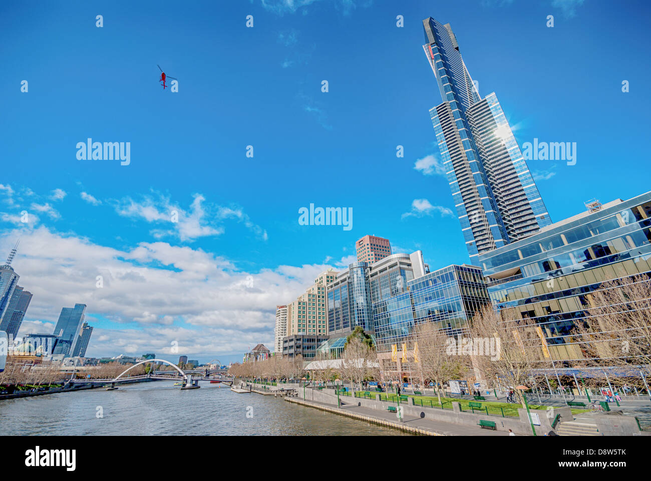 An uncorrected wide angle view of a helicopter flying over the Yarra River to Southbank, in downtown Melbourne, Australia. Stock Photo