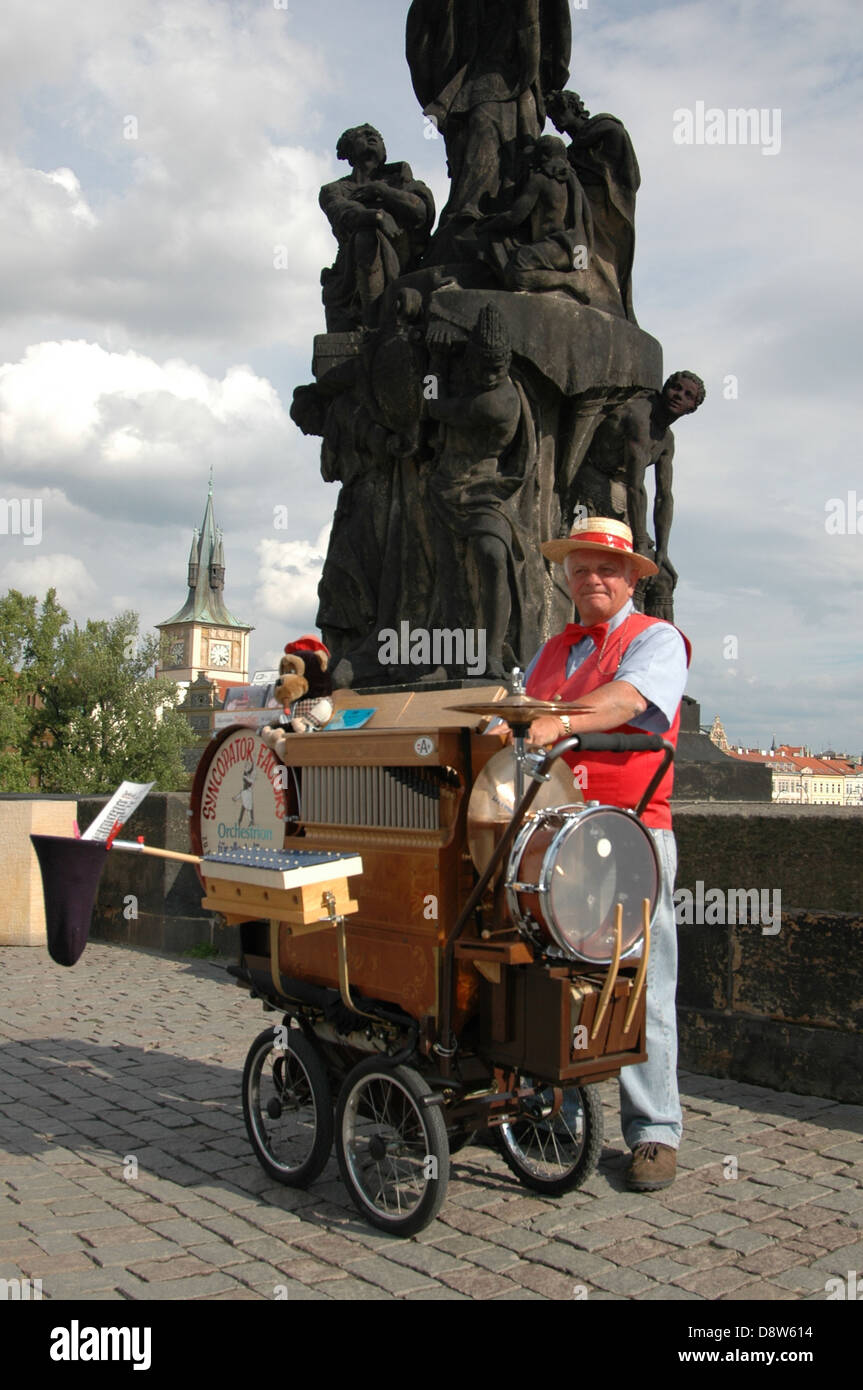 A one man band busker performing in Charles Bridge or Karluv Most Prague Czech republic Stock Photo