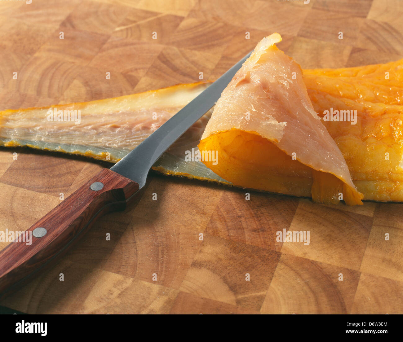 Taking the skin off a smoked haddock Stock Photo Alamy