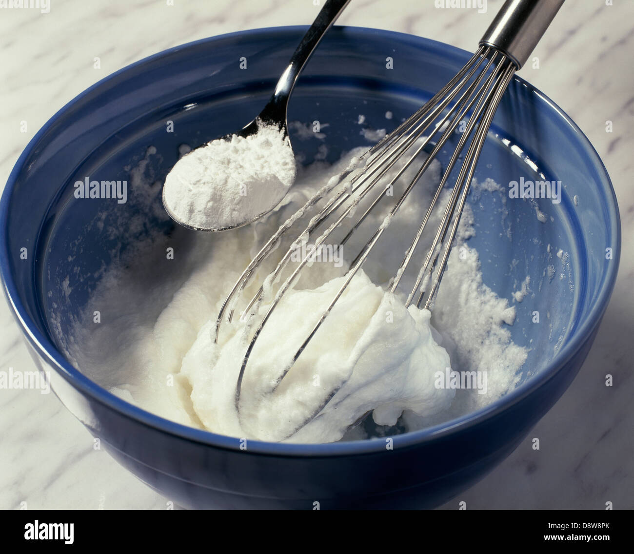 Beating the egg whites and adding the icing sugar Stock Photo Alamy