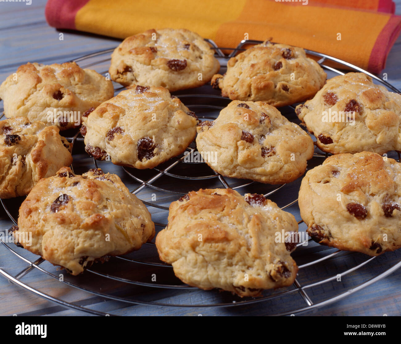 Coating the cookies with a mixture of milk and sugar before taking out of the oven Stock Photo