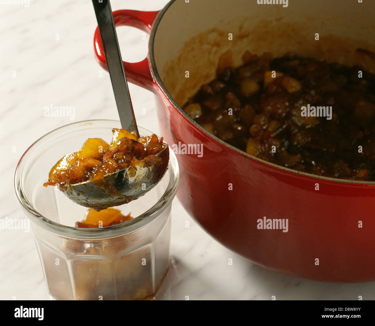 Placing the hot chutney into jars Stock Photo Alamy