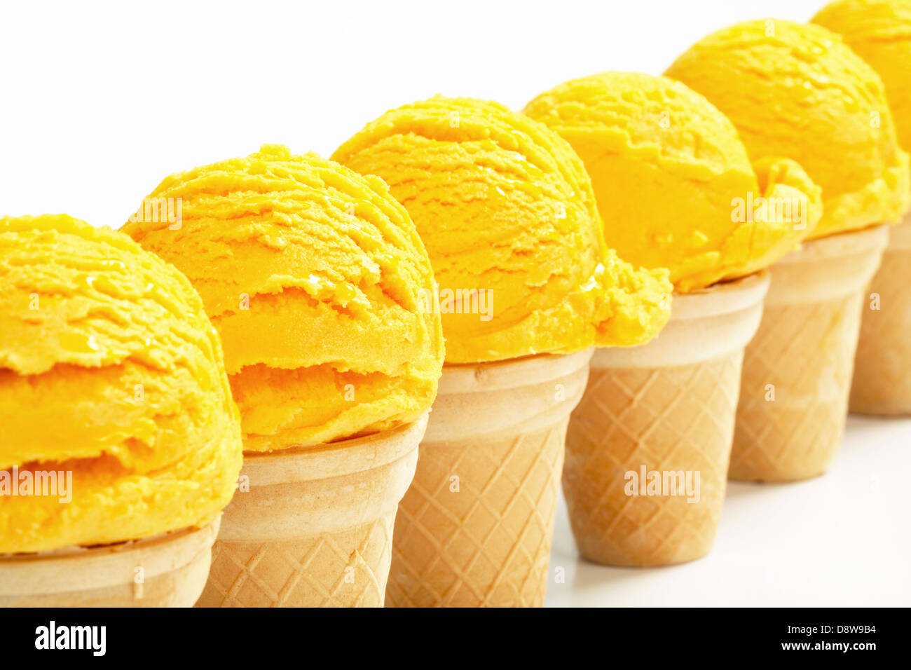 Yellow ice cream cones arranged in a row Stock Photo Alamy