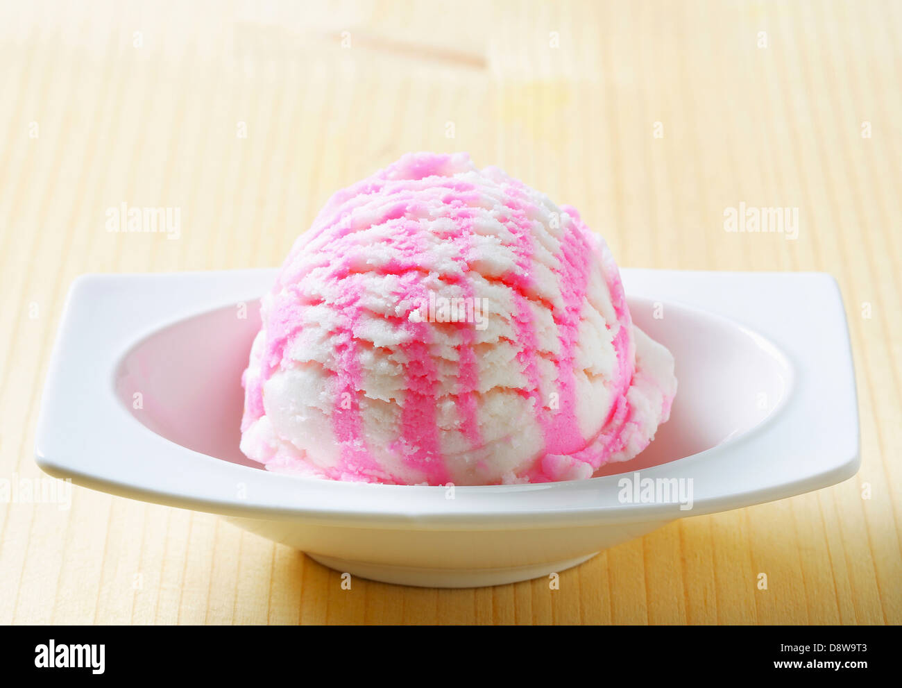 Scoop of white pink ice cream in a dessert dish Stock Photo