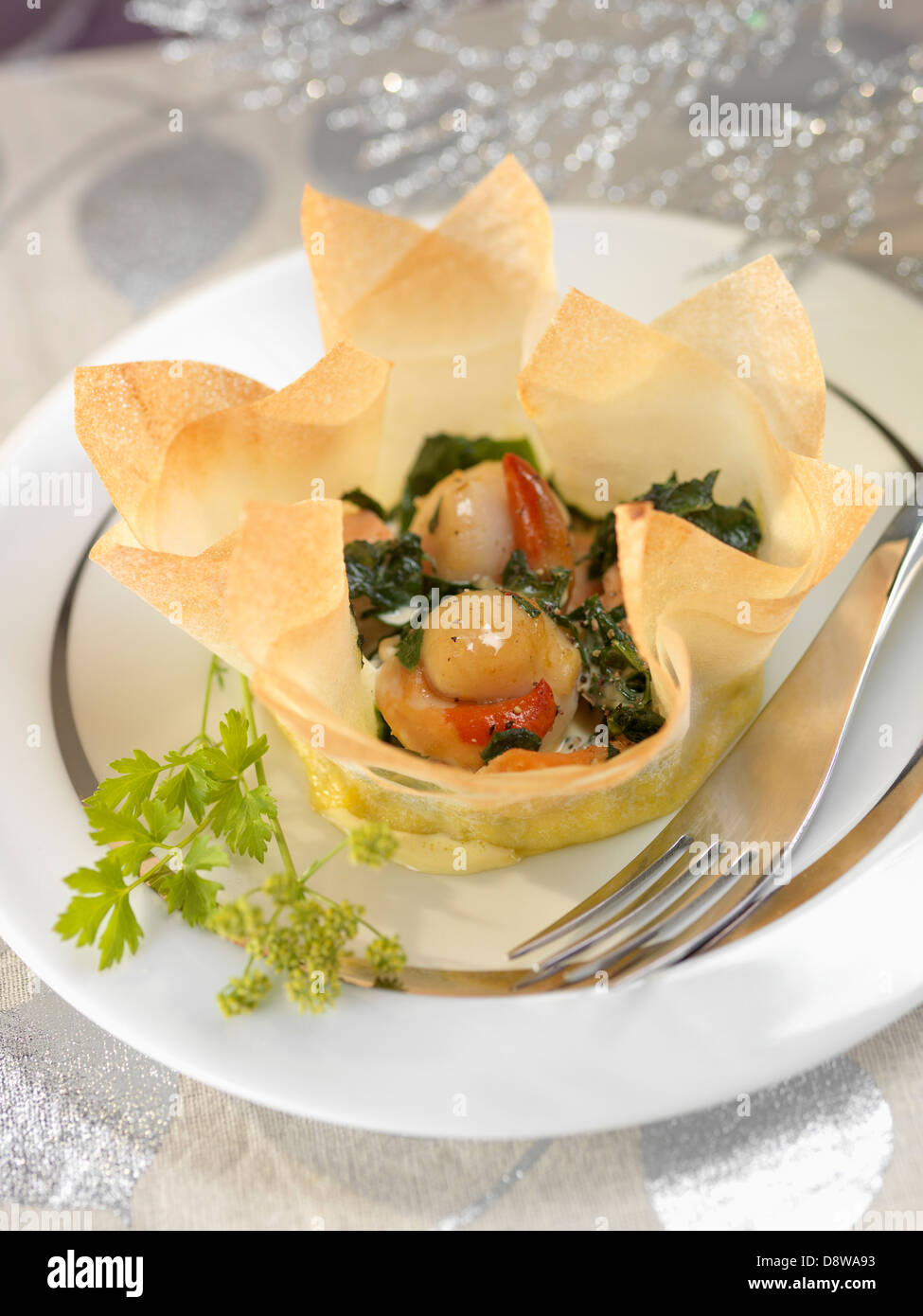 Scallops and salmon cooked in a filo pastry casing Stock Photo