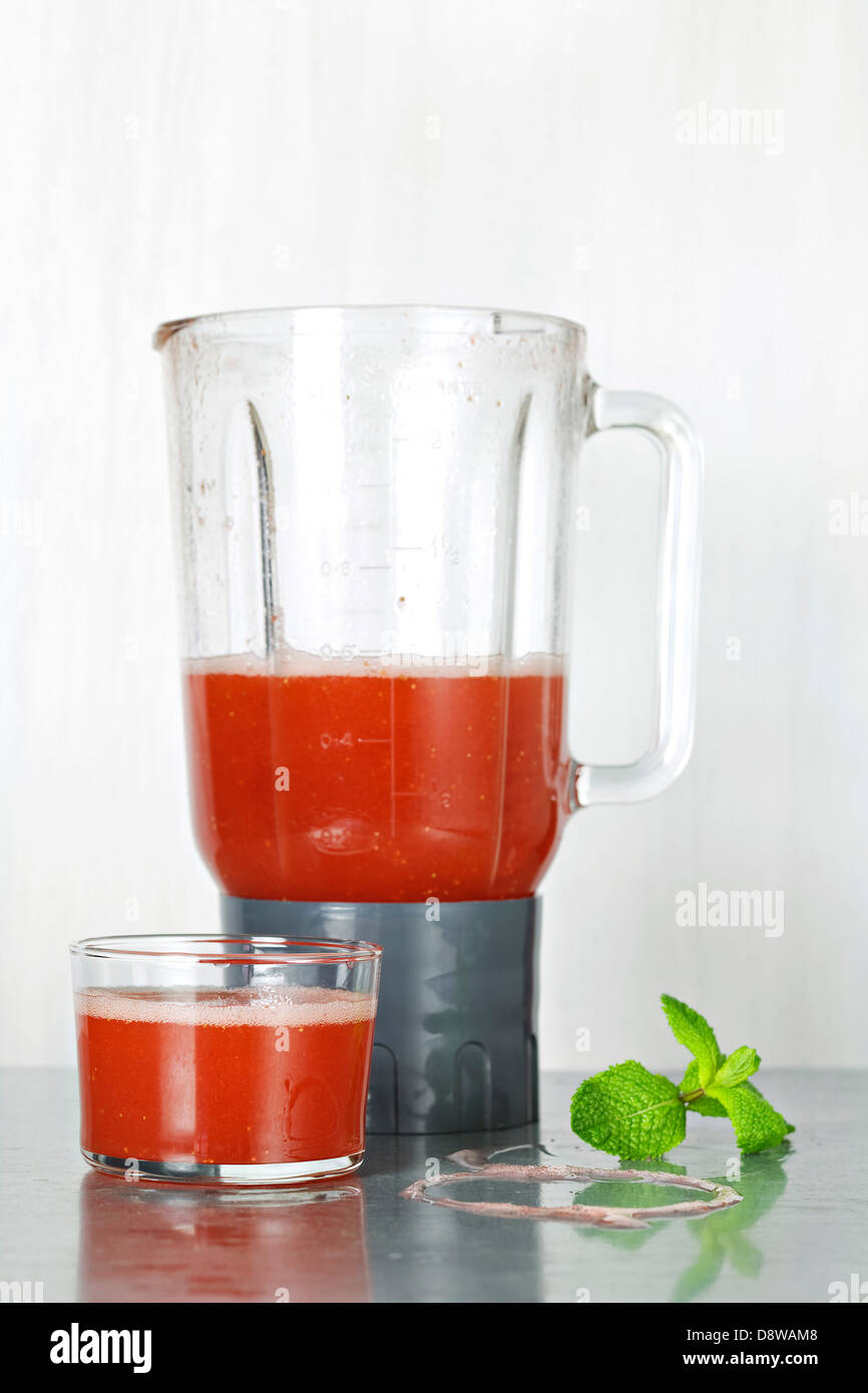 Preparing a strawberry smoothie in a blender Stock Photo Alamy