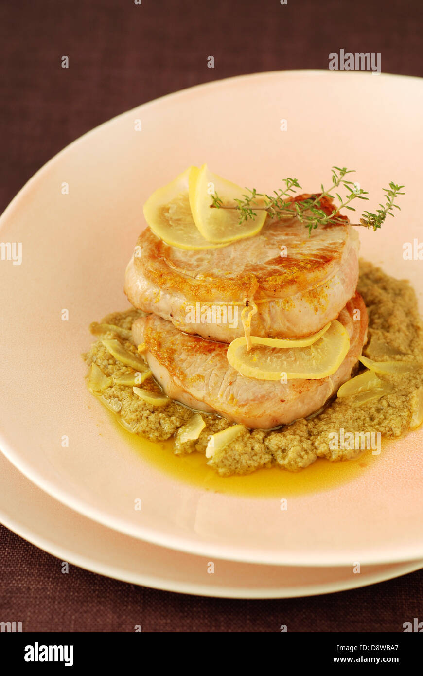 Lamb fillets with green olive tapenade ,confit citrus and colombo Stock