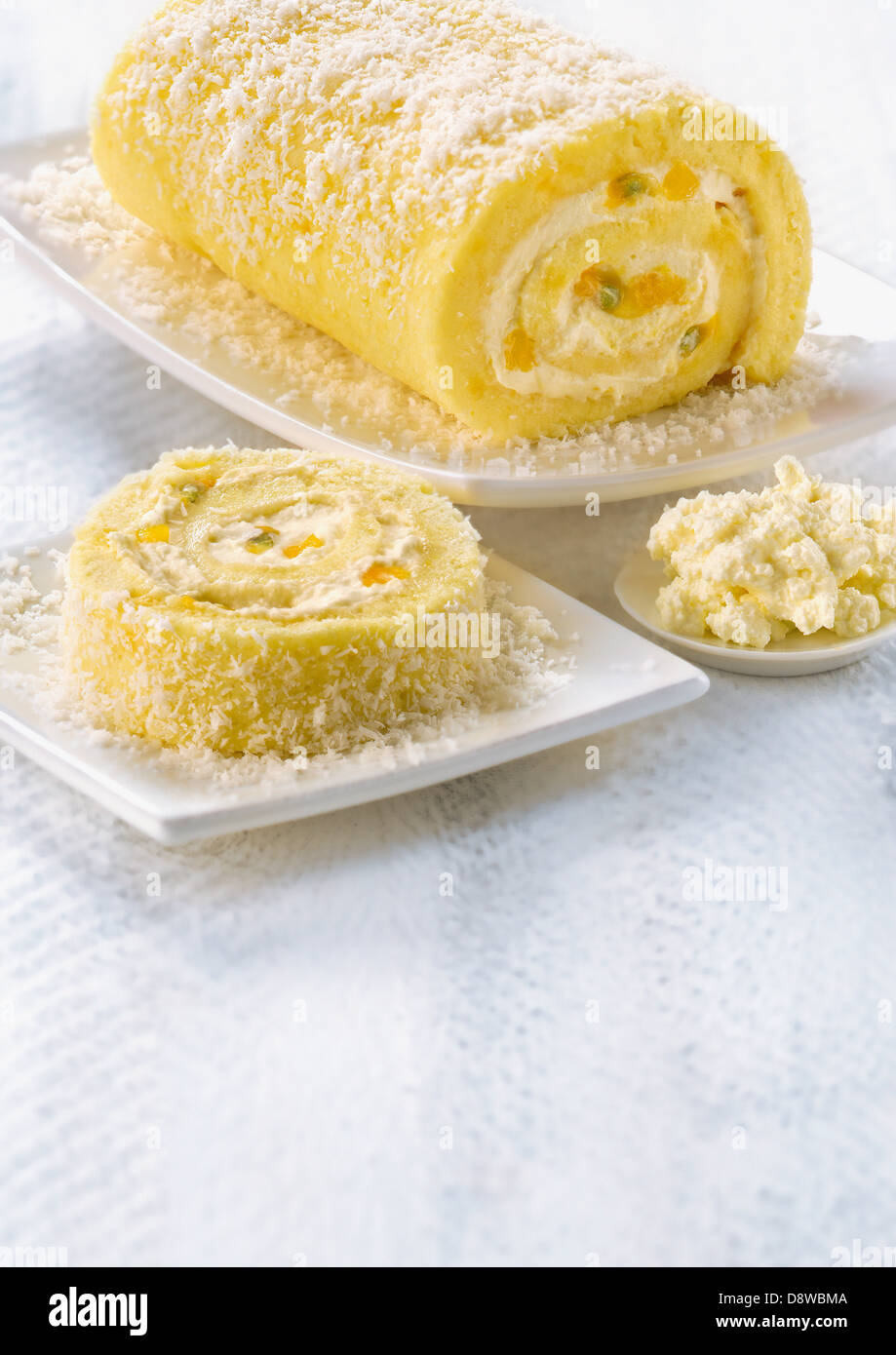 Rolled sponge cake wth Brousse cream,coconut,passion fruit mango filling Stock Photo