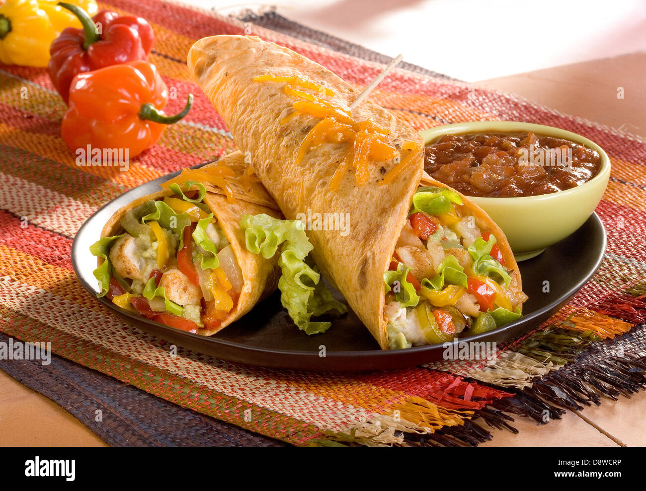Chicken,rice and vegetable burritos with spicy tomato salsa Stock Photo