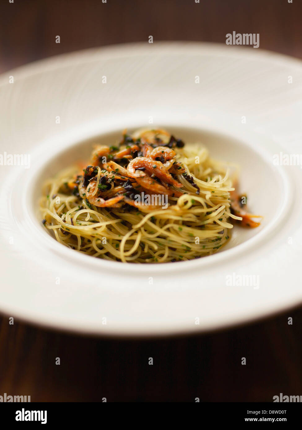 Italian-style chinese noodles with shrimps Stock Photo
