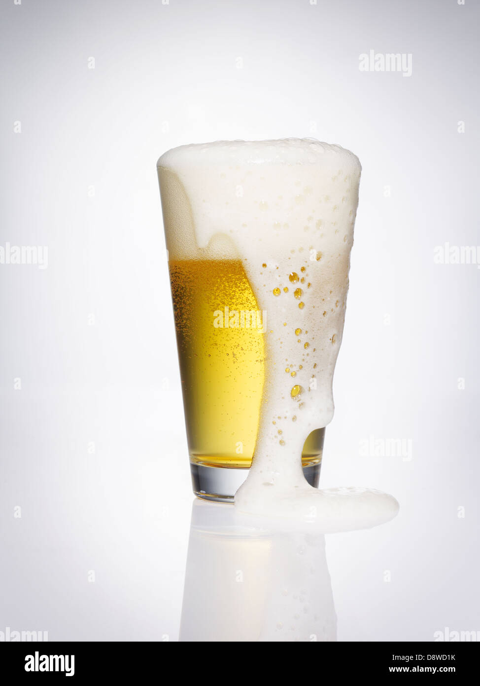 Glass of beer overflowing,studio shot Stock Photo Alamy