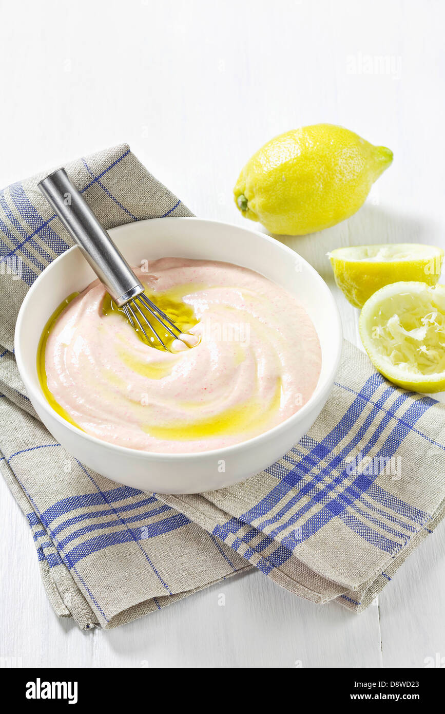 Mixing the olive oil and lemon juice to the Tarama mixture Stock Photo