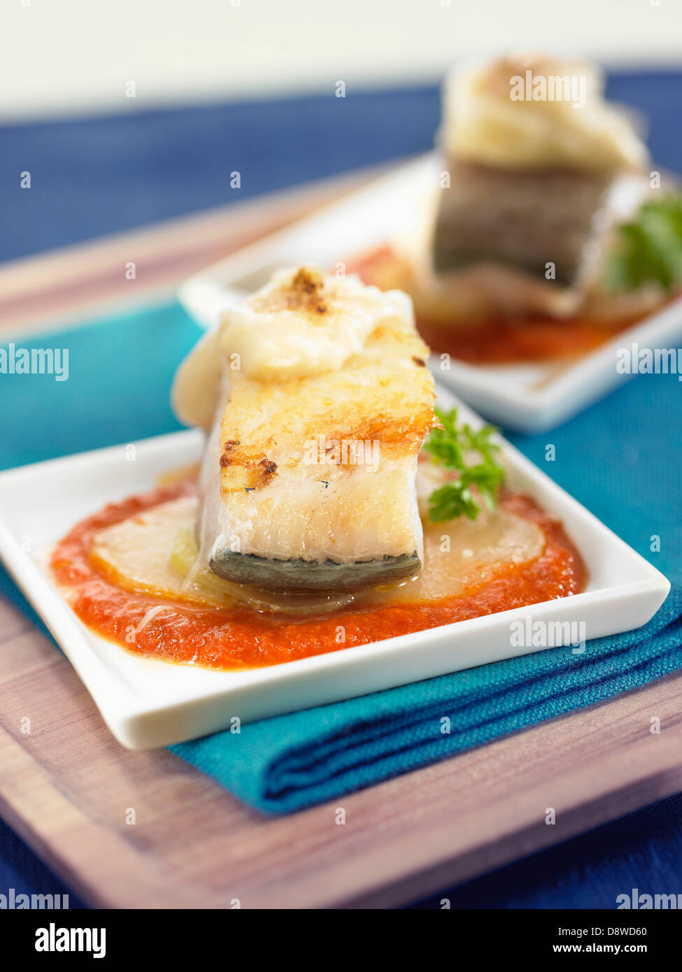 Salt-cod with onions,potatoes,melted cheese and tomato sauce Stock Photo