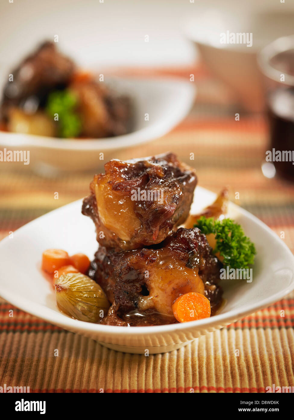 Bull's tail in tomato and onion sauce with carrots and potatoes Stock Photo