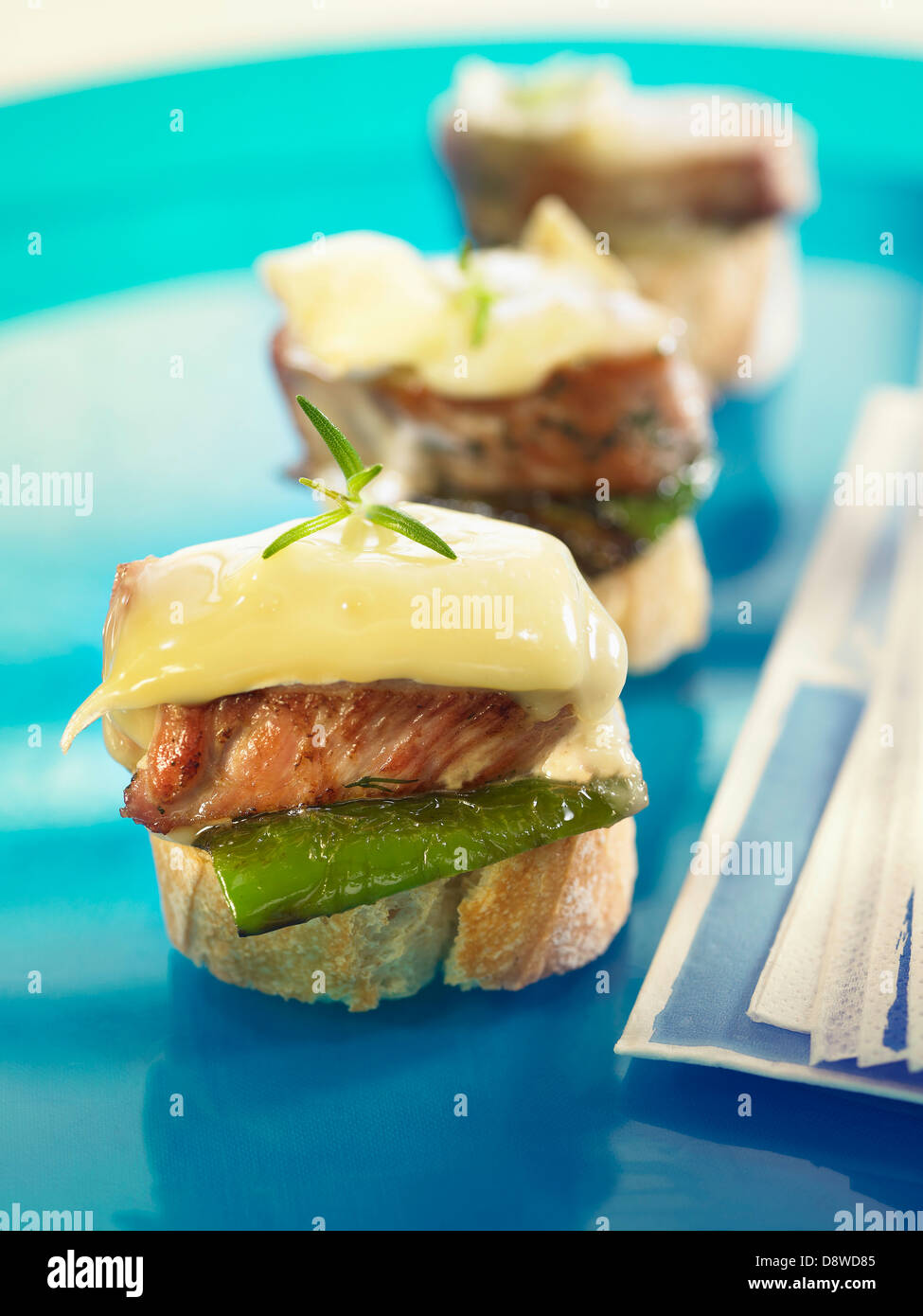 Pork filet,melted Brie and green pepper crostini Stock Photo