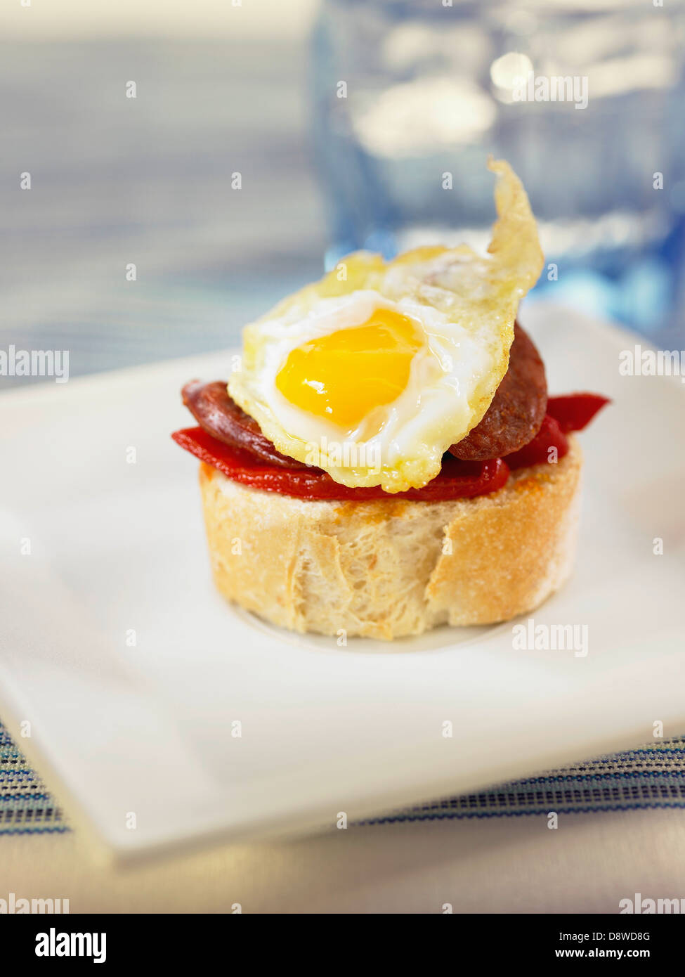 Fried quail's egg,Chorizo and piquillo pepper crostini Stock Photo - Alamy